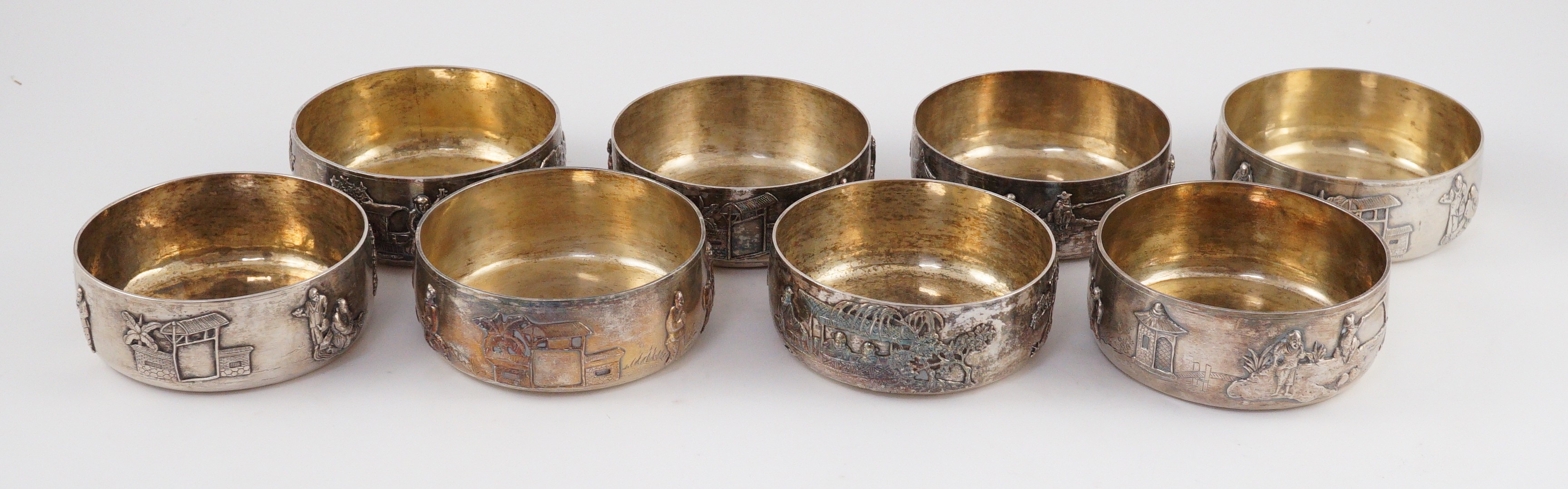 A set of four Chinese Export silver finger bowls, by Wang Hing, Hong Kong and one other set of four Chinese Export silver finger bowls